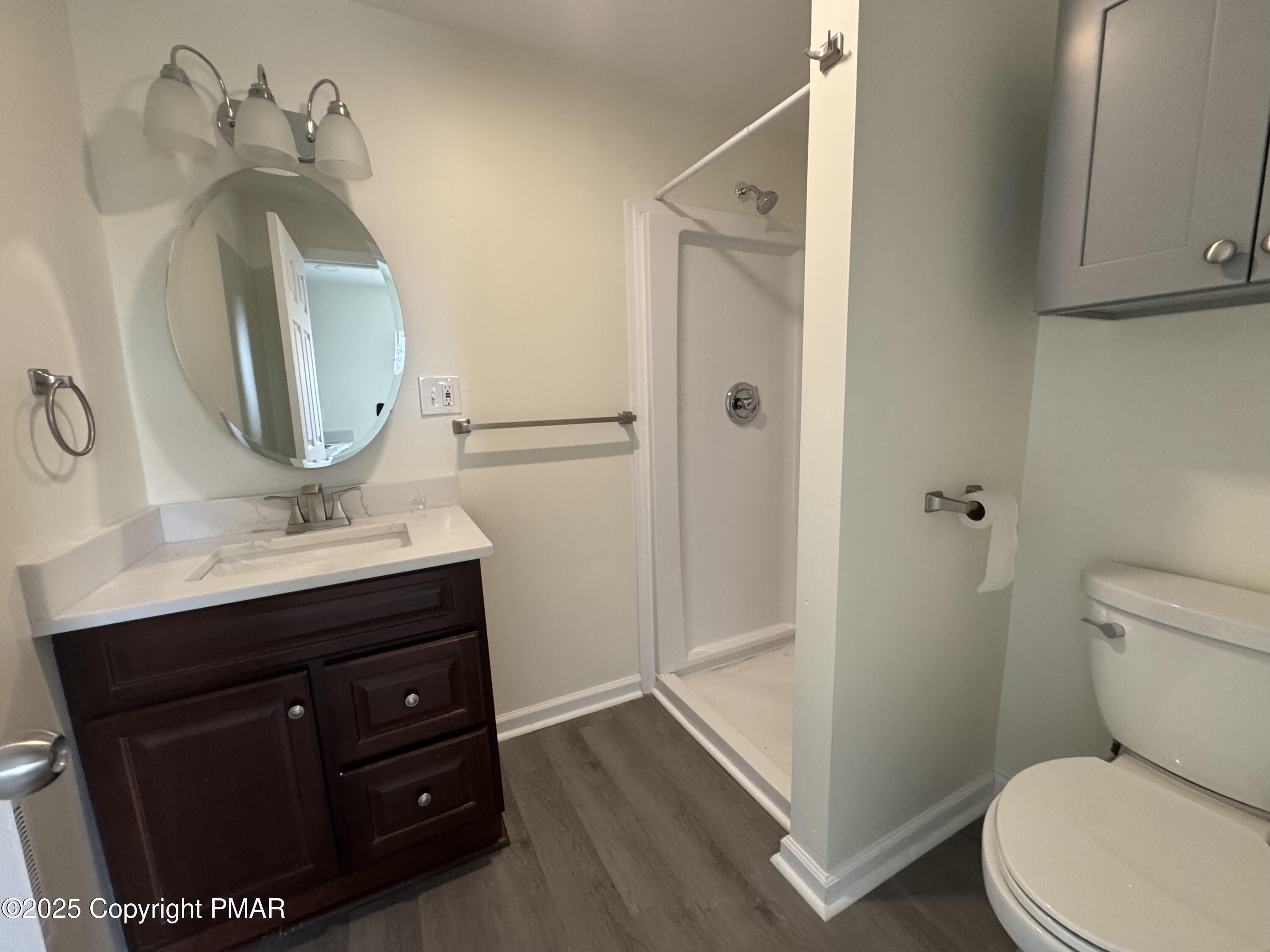 807 Chestnut Street, Unit 2 Coplay, PA 18037 - Photo 9 of 13 a bathroom with a toilet a sink and mirror