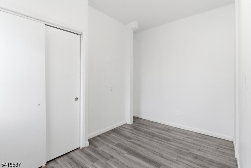 5 Elm Street, Unit 3 Newark, NJ 07102 - Photo 14 of 15 a view of an empty room with wooden floor