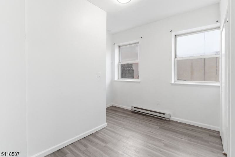 5 Elm Street, Unit 3 Newark, NJ 07102 - Photo 15 of 15 an empty room with wooden floor and windows