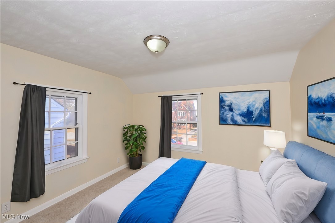 3938 Lansdale Road Cleveland, OH 44118 - Photo 23 of 34 Carpeted bedroom with vaulted ceiling and multiple windows