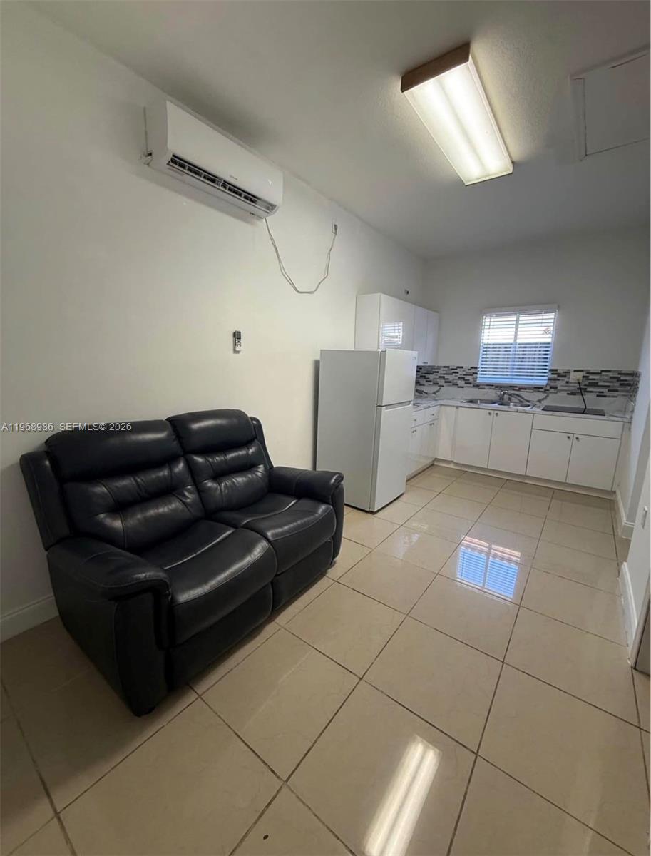 23160 Southwest 113 Passage, Unit 2 Miami, FL 33170 - Photo 1 of 12 a living room with a couch and a potted plant
