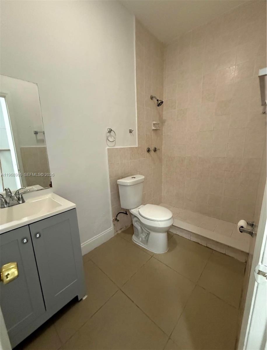 23160 Southwest 113 Passage, Unit 2 Miami, FL 33170 - Photo 11 of 12 a bathroom with a granite countertop toilet and sink