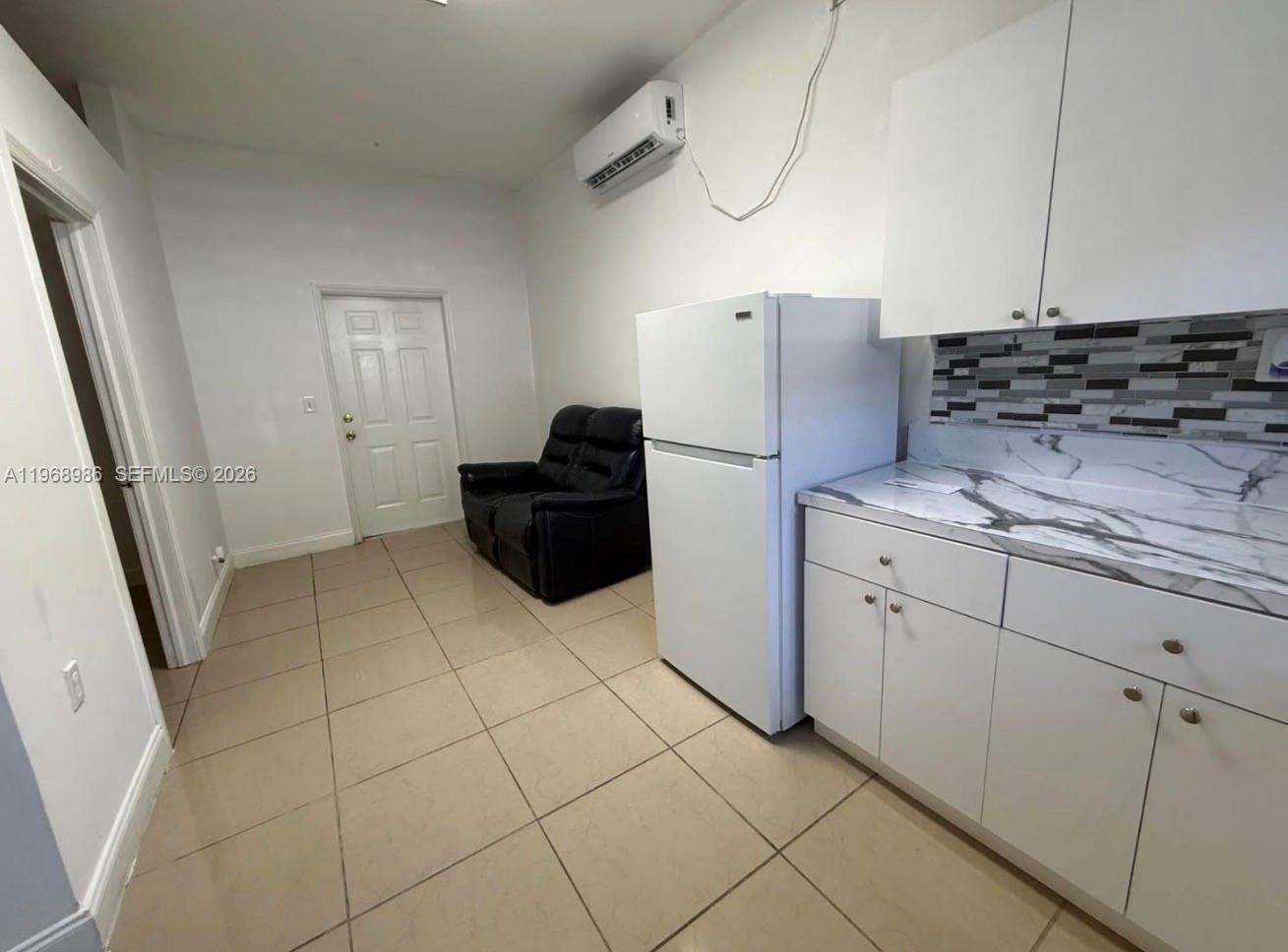 23160 Southwest 113 Passage, Unit 2 Miami, FL 33170 - Photo 3 of 12 a kitchen with cabinets and appliances