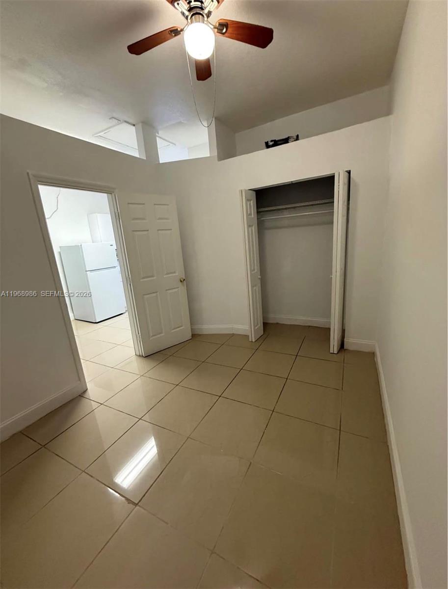 23160 Southwest 113 Passage, Unit 2 Miami, FL 33170 - Photo 10 of 12 a view of an empty room with a window