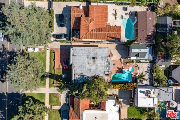 an aerial view of residential houses with outdoor space and street view