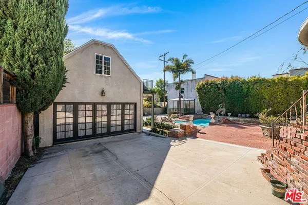 a view of a house with backyard and sitting area