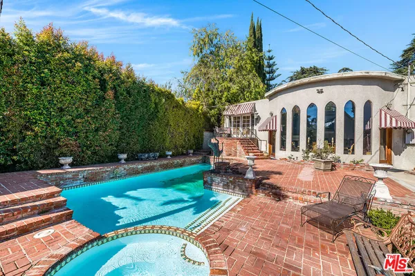 a view of a house with backyard and sitting area