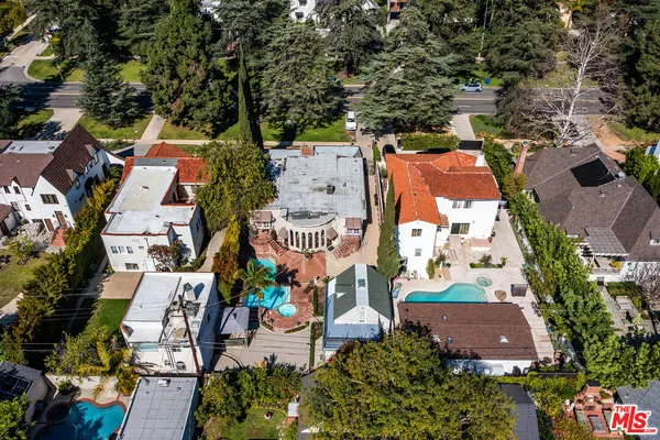 an aerial view of residential houses with outdoor space and street view