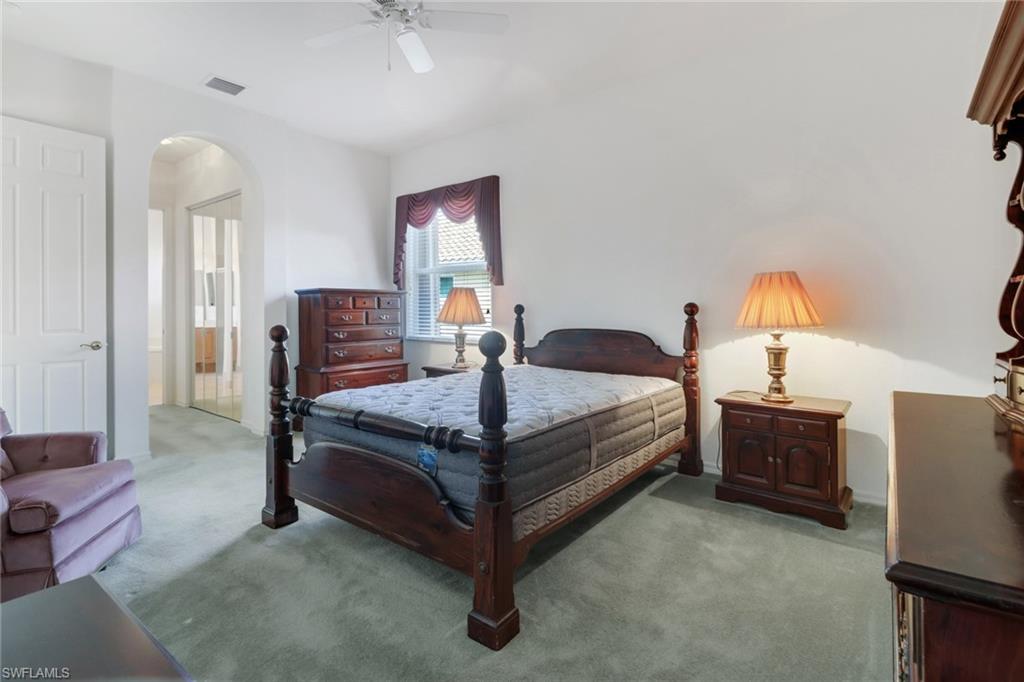 9246 Springview Loop Estero, FL 33928 - Photo 21 of 44 a bedroom with a bed and a chandelier