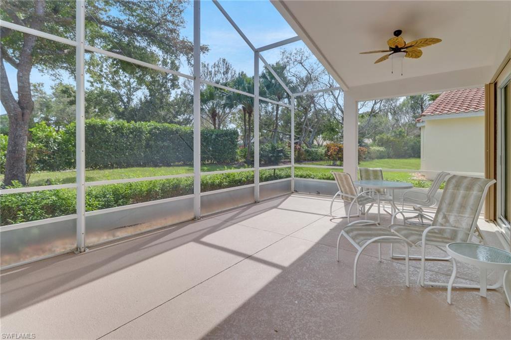 9246 Springview Loop Estero, FL 33928 - Photo 25 of 44 a view of a porch with a table chairs and a backyard