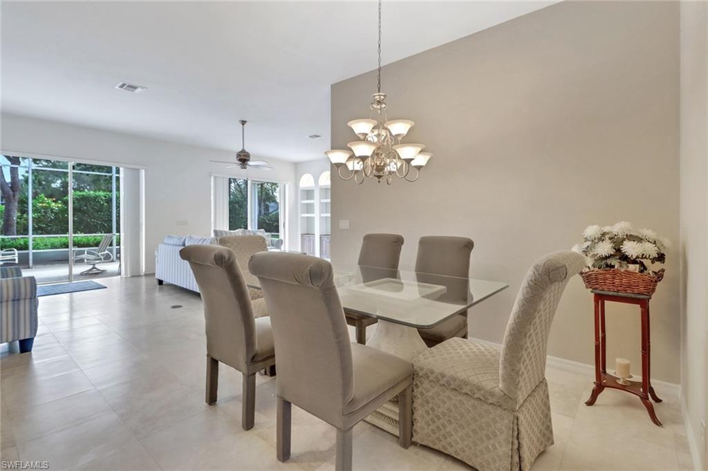 9246 Springview Loop Estero, FL 33928 - Photo 9 of 44 a view of a dining room with furniture and wooden floor