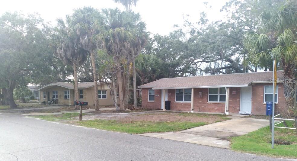 6709 River Road New Port Richey, FL 34652 - Photo 1 of 1 a view of a house with a yard and large tree