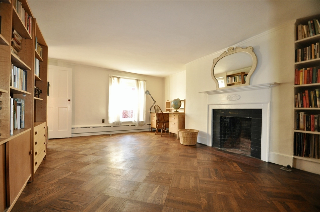51 Pinckney Street Boston, MA 02114 - Photo 13 of 16 a view of an empty room with a fireplace and a window