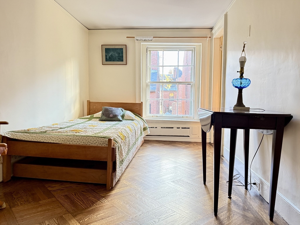 51 Pinckney Street Boston, MA 02114 - Photo 14 of 16 a bedroom with a bed window and a potted plant