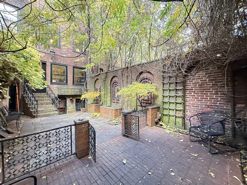 51 Pinckney Street Boston, MA 02114 - Photo 16 of 16 a front view of a house with garden