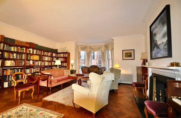 a living room with furniture large window and a fireplace
