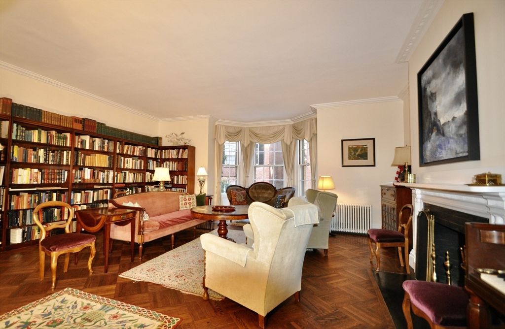 51 Pinckney Street Boston, MA 02114 - Photo 4 of 16 a living room with furniture large window and a fireplace