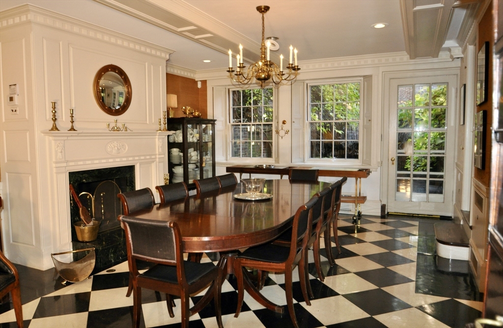 51 Pinckney Street Boston, MA 02114 - Photo 7 of 16 a dining room with furniture a fireplace and a chandelier