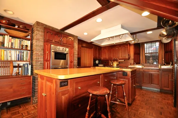 a kitchen with a sink a counter top space and stainless steel appliances