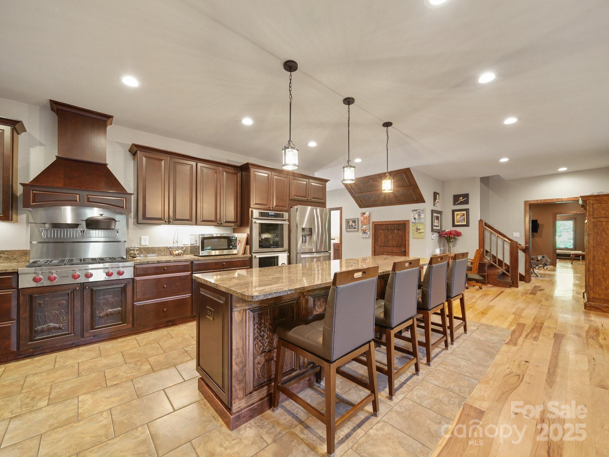 6153 Barclay Lane Clover, SC 29710 - Photo 4 of 27 a kitchen with stainless steel appliances granite countertop a stove top oven a sink a dining table and chairs