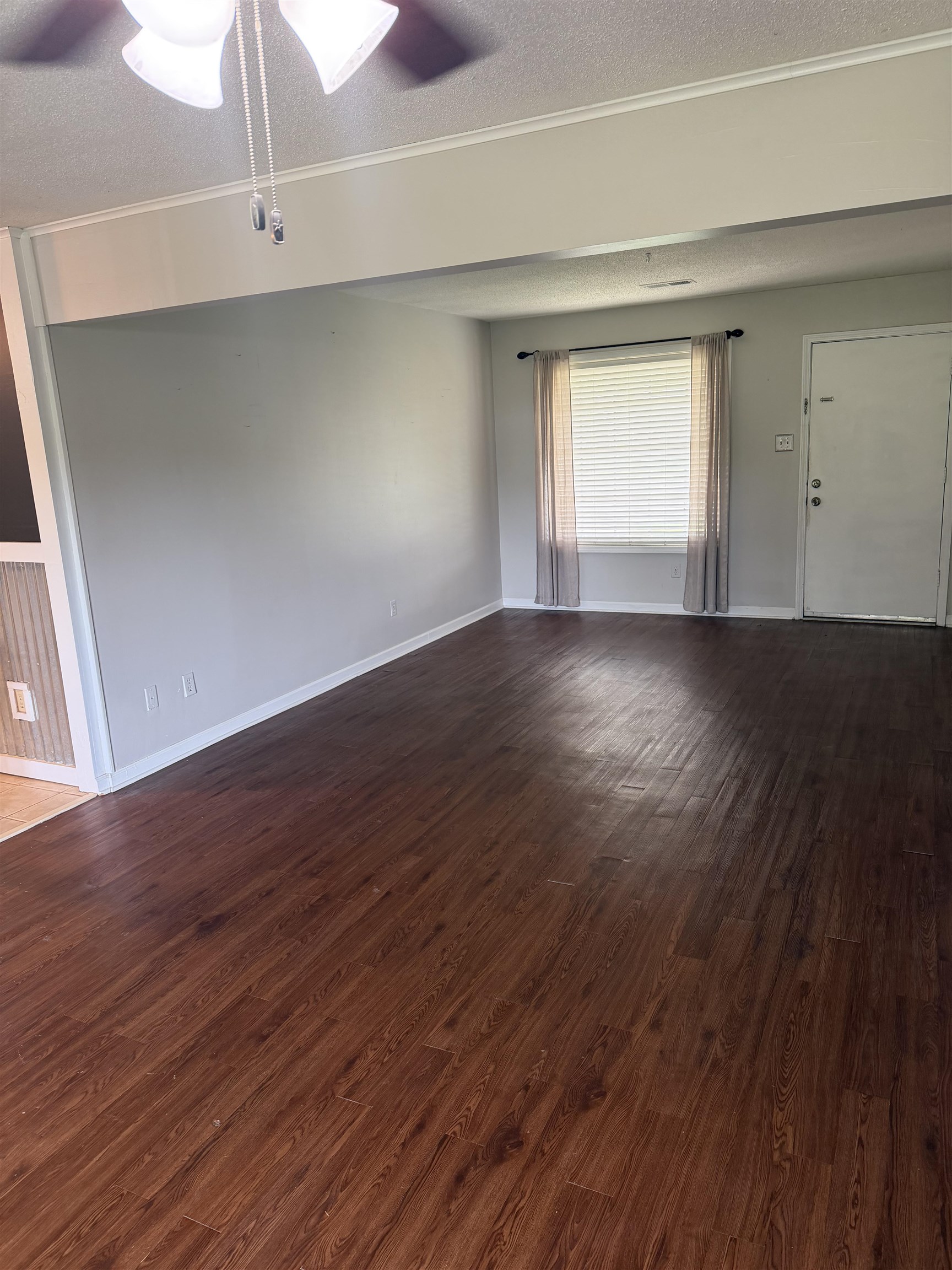 7919 Max Drive Millington, TN 38053 - Photo 11 of 13 a view of an empty room with wooden floor and window