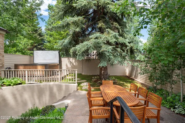 a view of patio with table and chairs and potted plants