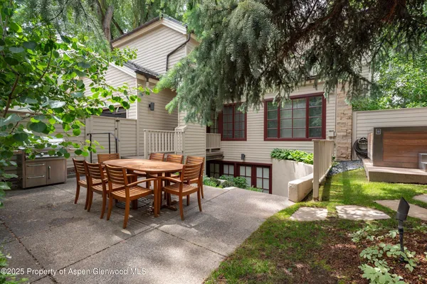 a view of a house with backyard and sitting area
