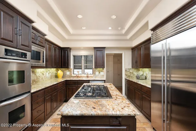 a kitchen with a stove and a refrigerator