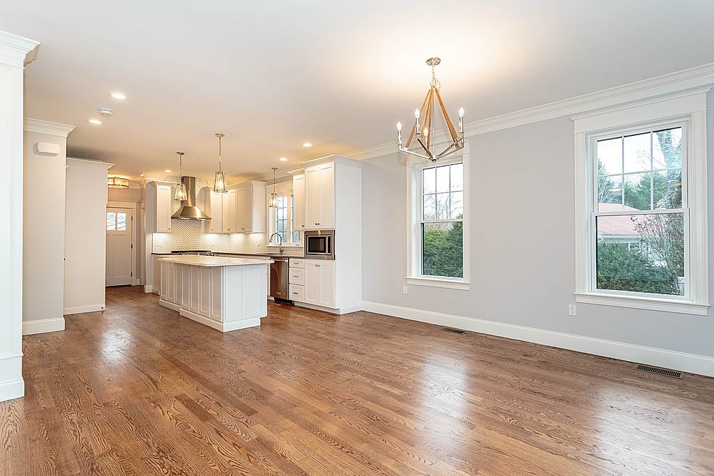 8 Cleveland Road, Unit A Winchester, MA 01890 - Photo 11 of 26 a view of kitchen with kitchen island wooden floors appliances and sink