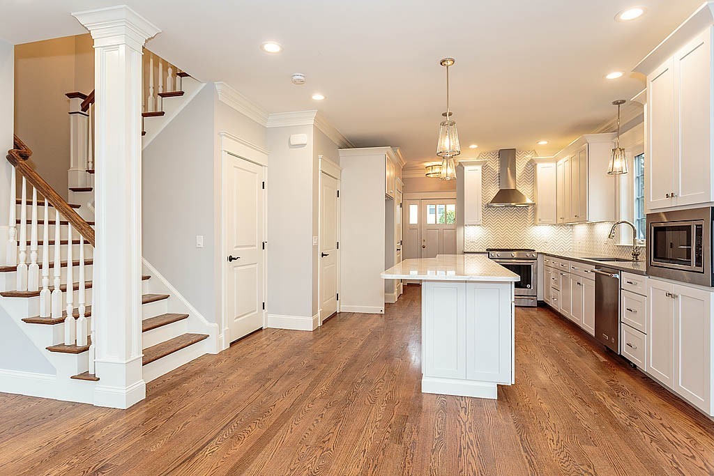 8 Cleveland Road, Unit A Winchester, MA 01890 - Photo 12 of 26 a large kitchen with cabinets wooden floor and stainless steel appliances