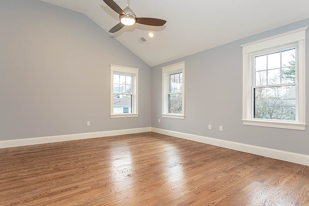 8 Cleveland Road, Unit A Winchester, MA 01890 - Photo 13 of 26 a view of an empty room with wooden floor and a window