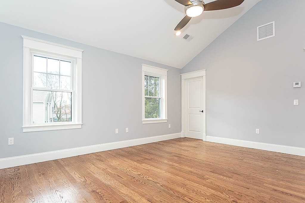8 Cleveland Road, Unit A Winchester, MA 01890 - Photo 14 of 26 a view of an empty room with wooden floor and a window