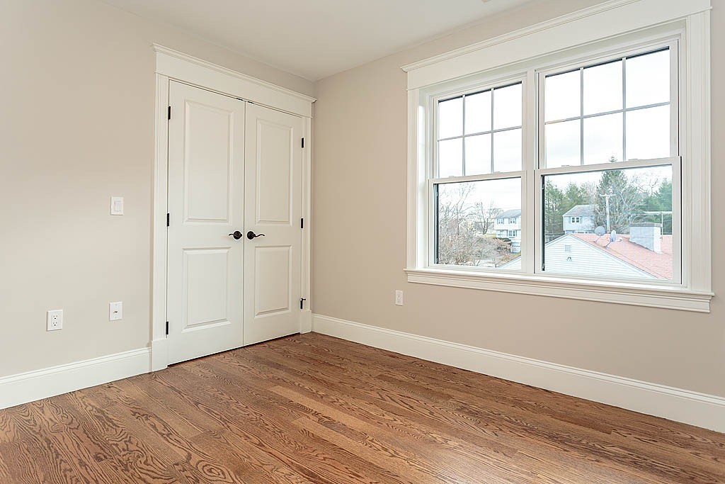 8 Cleveland Road, Unit A Winchester, MA 01890 - Photo 18 of 26 an empty room with wooden floor and windows