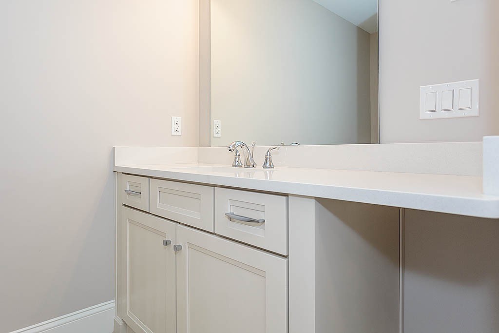 8 Cleveland Road, Unit A Winchester, MA 01890 - Photo 21 of 26 a bathroom with a sink vanity and a mirror
