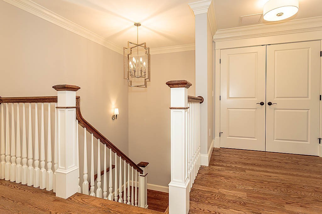 8 Cleveland Road, Unit A Winchester, MA 01890 - Photo 23 of 26 a view of a hallway with wooden floor and staircase