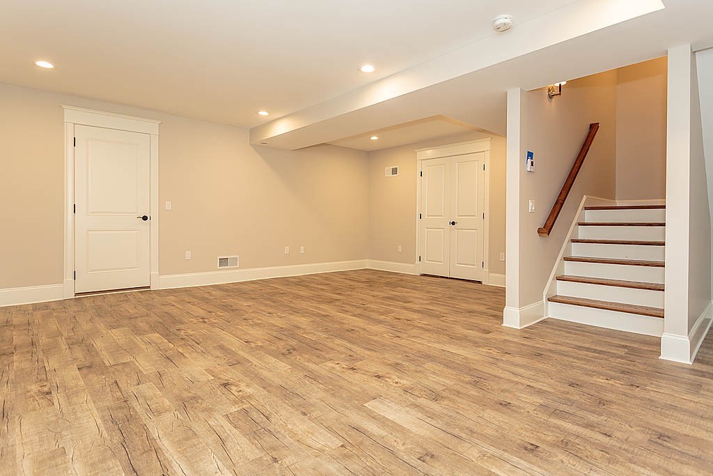 8 Cleveland Road, Unit A Winchester, MA 01890 - Photo 24 of 26 a view of an empty room with wooden floor and stairs