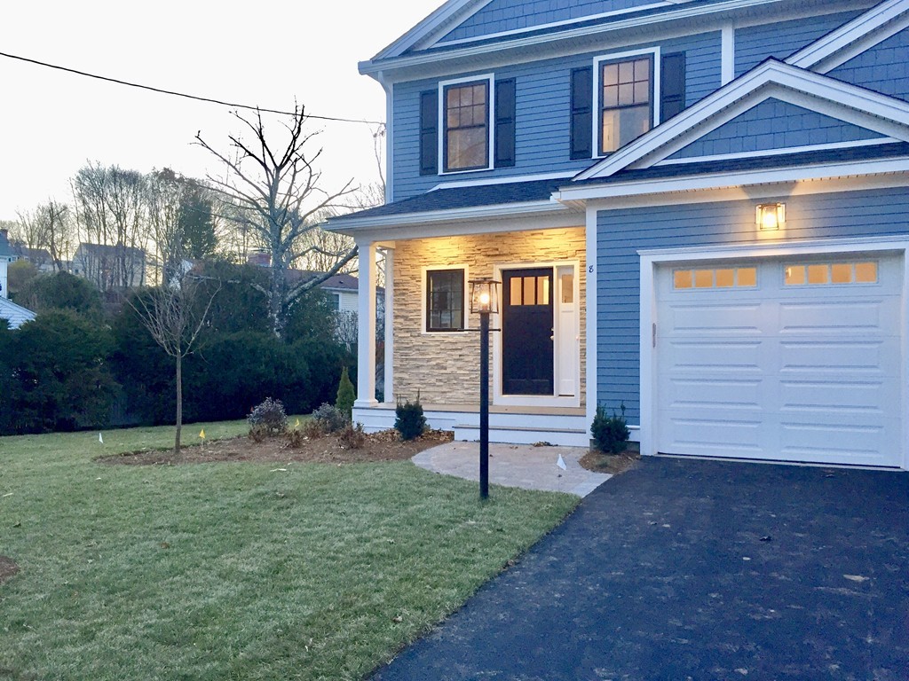 8 Cleveland Road, Unit A Winchester, MA 01890 - Photo 5 of 26 a view of a brick house with a yard and plants