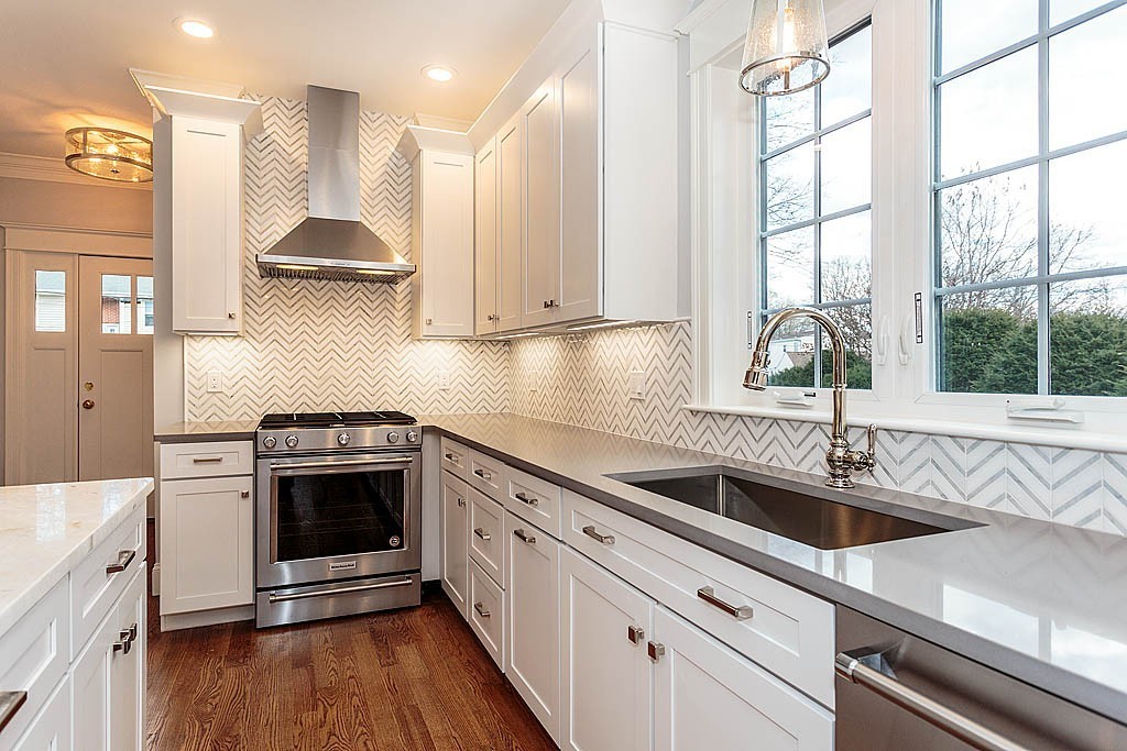 8 Cleveland Road, Unit A Winchester, MA 01890 - Photo 7 of 26 a kitchen with stainless steel appliances granite countertop a sink and a stove