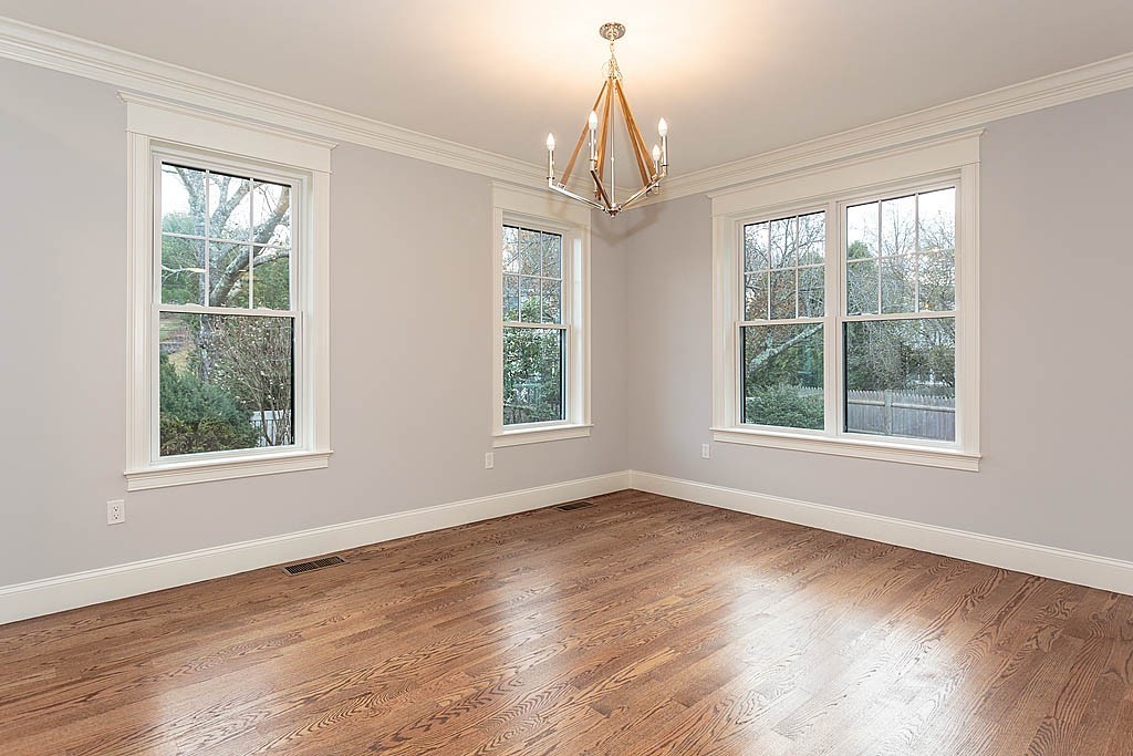 8 Cleveland Road, Unit A Winchester, MA 01890 - Photo 9 of 26 a view of an empty room with wooden floor and a window