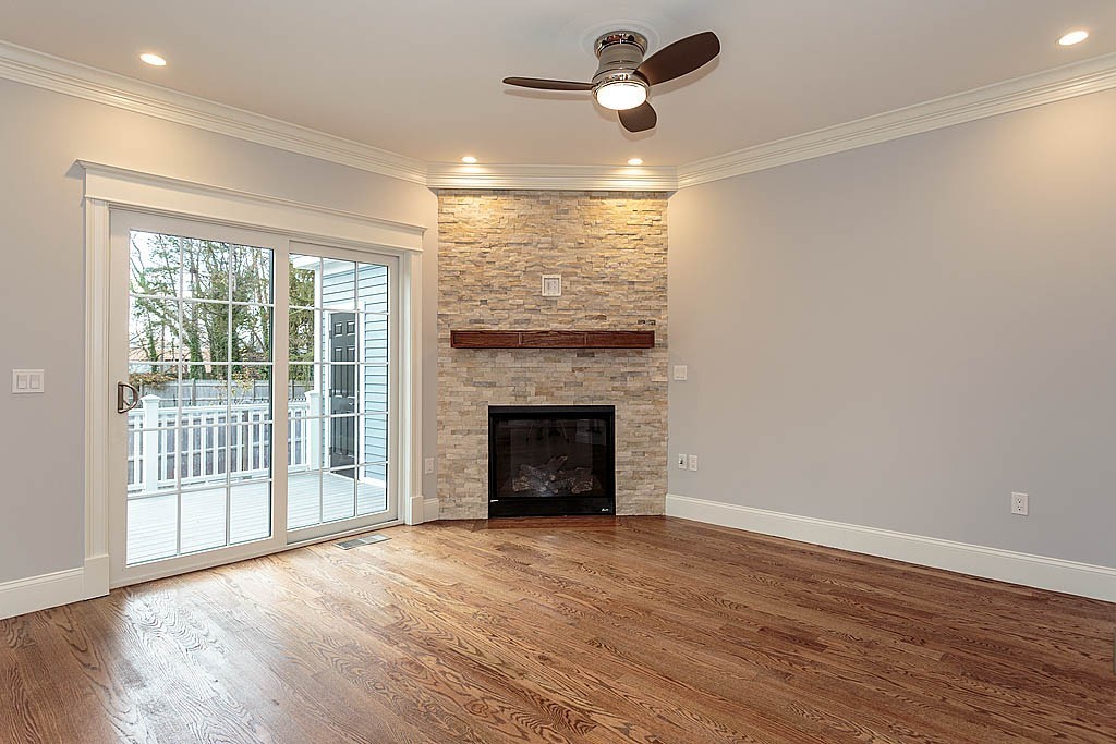8 Cleveland Road, Unit A Winchester, MA 01890 - Photo 10 of 26 a view of an empty room with a window and a fireplace