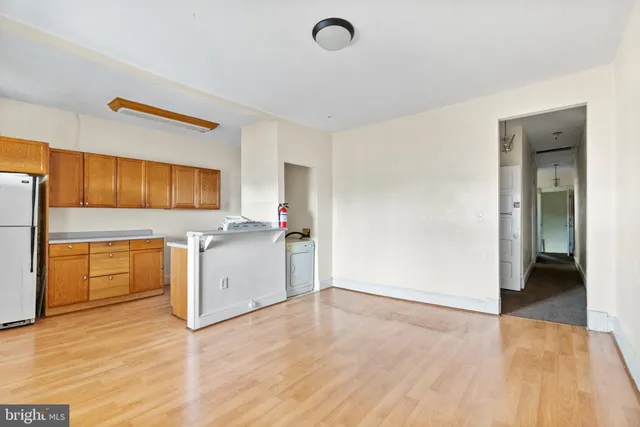 a view of a kitchen with a sink and a refrigerator