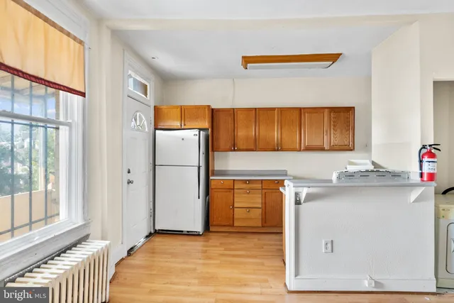 a kitchen with a sink cabinets and a refrigerator