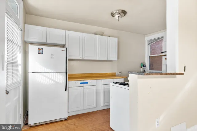 a white refrigerator freezer sitting inside of a kitchen