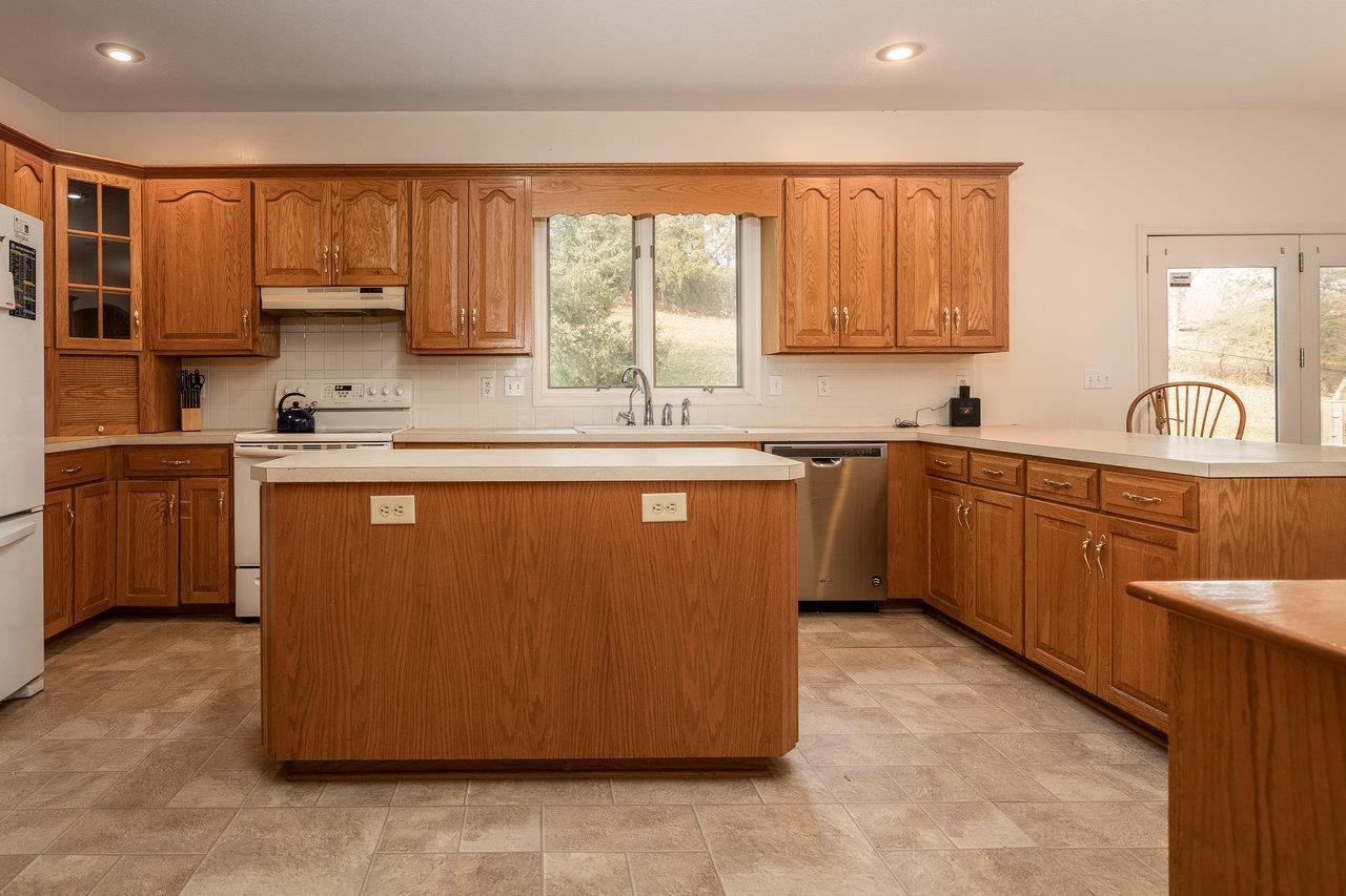 7664 Kiser Road Mount Crawford, VA 22841 - Photo 7 of 45 a kitchen with stainless steel appliances granite countertop a sink a stove a refrigerator cabinets and a window