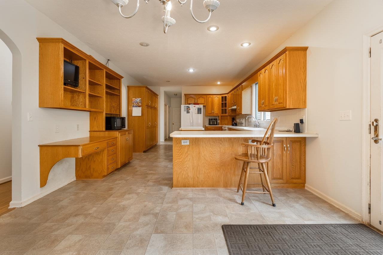 7664 Kiser Road Mount Crawford, VA 22841 - Photo 8 of 45 a kitchen with stainless steel appliances kitchen island granite countertop a stove a sink and a refrigerator
