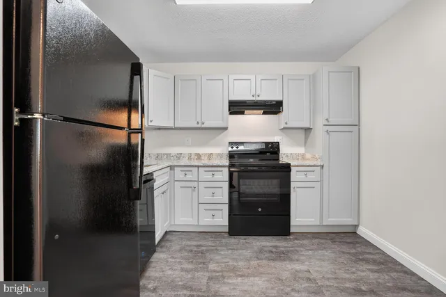 a kitchen with stainless steel appliances a refrigerator and a stove
