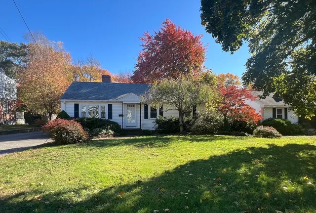 a front view of a house with yard and green space