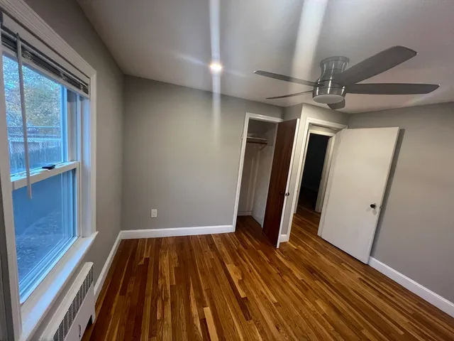 a view of a room with wooden floor and staircase
