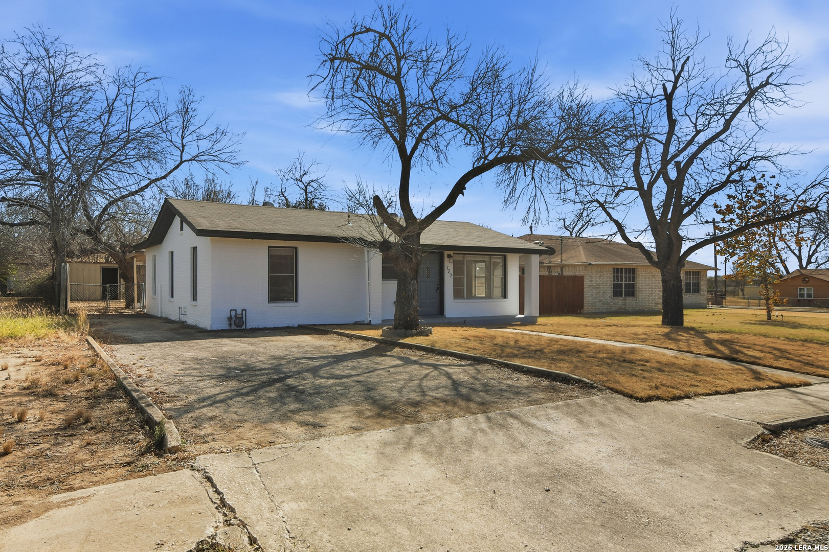 a view of a house with snow on the road