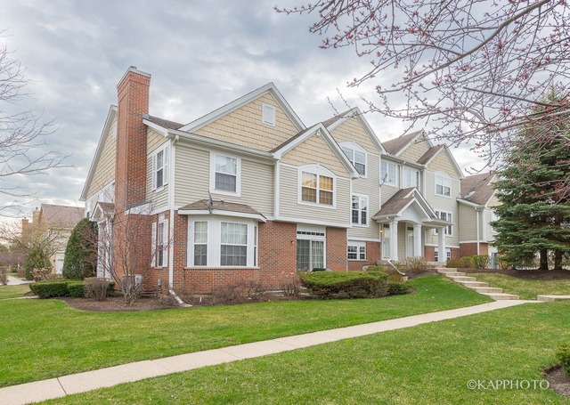 1270 Georgetown Way Vernon Hills, IL 60061 - Photo 2 of 25 a front view of a house with a garden and yard